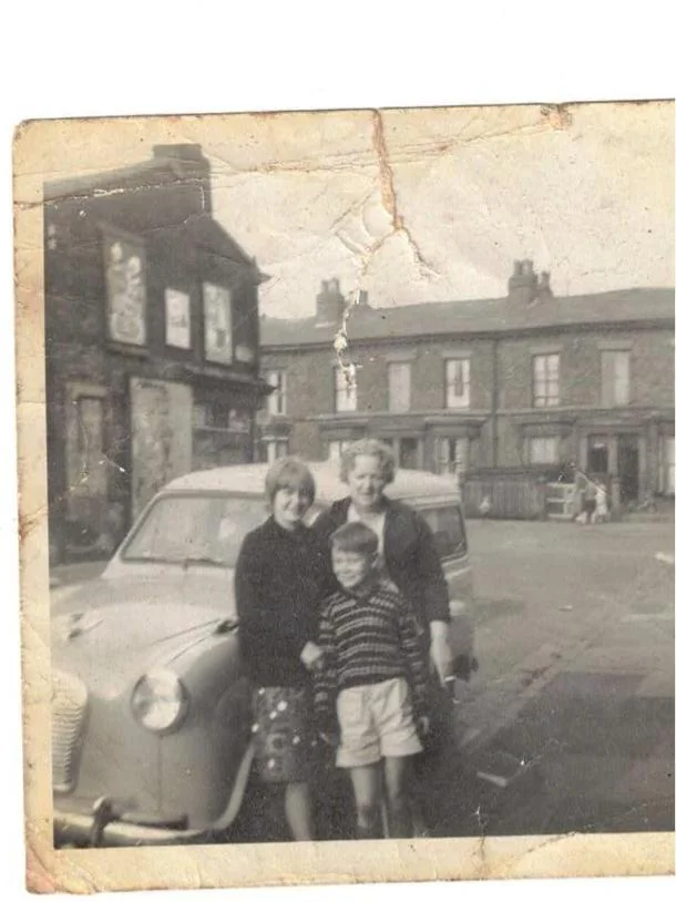 Original faded and yellowed vintage family portrait before AI color restoration